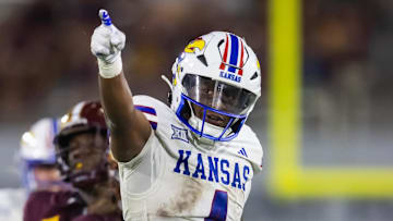 Oct 5, 2024; Tempe, Arizona, USA; Kansas Jayhawks running back Devin Neal (4) celebrates a play against the Arizona State Sun Devils in the second half at Mountain America Stadium. Mandatory Credit: Mark J. Rebilas-Imagn Images