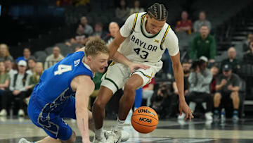 Nov 24, 2025; Las Vegas, Nevada, USA; Creighton Bluejays guard Josh Dix (4) and Baylor Bears guard Cameron Carr (43) battle for the loose ball during the second half in a 2025 Players Era Festival group play game at Michelob Ultra Arena.