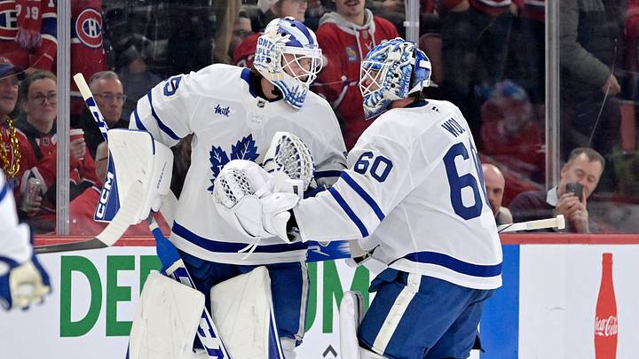 Nov 22, 2025; Montreal, Quebec, CAN; Toronto Maple Leafs goalie Dennis Hildeby (35) comes in to relieve teammate goalie Joseph Woll (60) during the second period of the game against the Montreal Canadiens at the Bell Centre. Mandatory Credit: Eric Bolte-Imagn Images