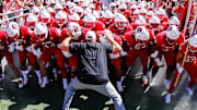 Oct 4, 2025; Raleigh, North Carolina, USA;  NC State Wolfpack head coach Dave Doeren with his team prepare to run out prior to the first half of the game against Campbell Fighting Camels at Carter-Finley Stadium. Mandatory Credit: Jaylynn Nash-Imagn Images
