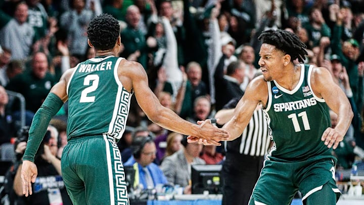 Michigan State guard Tyson Walker celebrates a 3-point basket with guard A.J. Hoggard during the first half of NCAA tournament West Region first round at Spectrum Center in Charlotte, N.C. on Thursday, March 21, 2024.