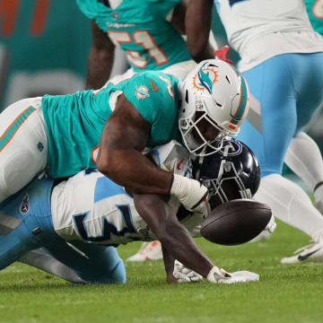 Miami Dolphins defensive tackle Da'Shawn Hand (93) forces a fumble by Tennessee Titans running back Tyjae Spears (32) during the first half of the Monday night game at Hard Rock Stadium last December.