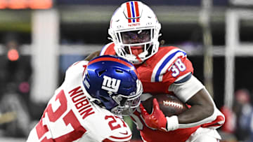 Dec 1, 2025; Foxborough, Massachusetts, USA; New England Patriots running back Rhamondre Stevenson (38) runs the ball against New York Giants safety Tyler Nubin (27) during the fourth quarter at Gillette Stadium.