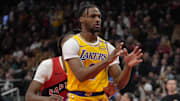 Nov 1, 2024; Toronto, Ontario, CAN; Los Angeles Lakers guard Bronny James (9) looks for a pass as Toronto Raptors guard Ja'Kobe Walter (14) defends during the second half at Scotiabank Arena. Mandatory Credit: John E. Sokolowski-Imagn Images