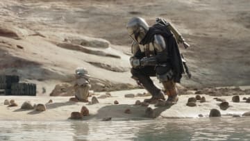 (L-R): Grogu and Din Djarin (Pedro Pascal) with stone crabs in Lucasfilm's THE MANDALORIAN, season three, exclusively on Disney+. ©2023 Lucasfilm Ltd. & TM. All Rights Reserved.