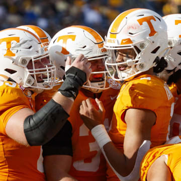 Tennessee Volunteers quarterback Nico Iamaleava (8), offensive lineman Brian Grant (73), wide receiver Jackson Locke (31), wide receiver Trey Weary (83) and wide receiver Chas Nimrod (81) celebrate a touchdown against the Iowa Hawkeyes during the third quarter at Camping World Stadium.