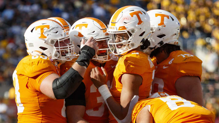 Tennessee Volunteers quarterback Nico Iamaleava (8), offensive lineman Brian Grant (73), wide receiver Jackson Locke (31), wide receiver Trey Weary (83) and wide receiver Chas Nimrod (81) celebrate a touchdown against the Iowa Hawkeyes during the third quarter at Camping World Stadium.