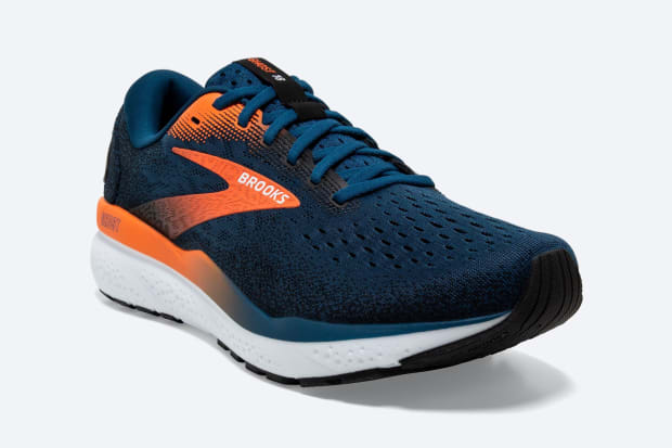 Side view of a blue and orange Brooks Running shoe.