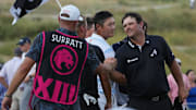 Sep 22, 2024; Carrolton, Texas, USA; Patrick Reed of the 4Aces GC shakes the hand of the caddie of Caleb Surratt of Legion XIII following his round on the 18th green during the LIV Golf Dallas Team Championship Finals at Maridoe Golf Club. Mandatory Credit: Jim Cowsert-Imagn Images