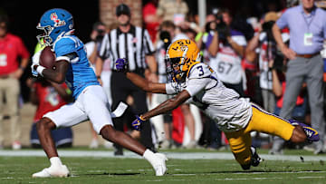 Sep 27, 2025; Oxford, Mississippi, USA; Mississippi Rebels wide receiver Deuce Alexander (11) runs after a catch as LSU Tigers cornerback DJ Pickett (3) attempts to make the tackle during the second quarter at Vaught-Hemingway Stadium. Mandatory Credit: Petre Thomas-Imagn Images