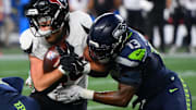 Oct 20, 2025; Seattle, Washington, USA; Seattle Seahawks linebacker Ernest Jones IV (13) tackles Houston Texans tight end Dalton Schultz (86) during the second quarter at Lumen Field. Mandatory Credit: Steven Bisig-Imagn Images