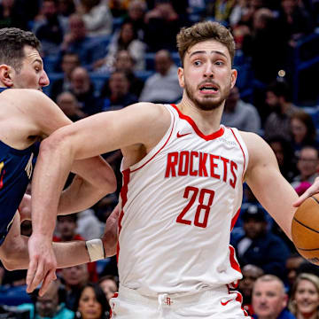 Mar 6, 2025; New Orleans, Louisiana, USA;  Houston Rockets center Alperen Sengun (28) dribbles against New Orleans Pelicans center Karlo Matkovic (17) during the second half at Smoothie King Center. Mandatory Credit: Stephen Lew-Imagn Images
