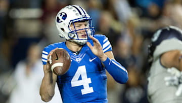 Oct 3, 2014; Provo, UT, USA; Brigham Young Cougars quarterback Taysom Hill (4) drops back to pass during the first half against the Utah State Aggies at Lavell Edwards Stadium. Utah State won 35-20. Mandatory Credit: Russ Isabella-Imagn Images