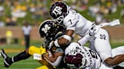Oct 16, 2021; Columbia, Missouri, USA; Missouri Tigers wide receiver Tauskie Dove (86) is tackled by Texas A&MM Aggies defensive back Tyreek Chappell (7) and defensive back Leon O'Neal Jr. (9) during the second half at Faurot Field at Memorial Stadium. 