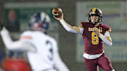 Walsh Jesuit quarterback Keller Moten looks to throw during the first half of a regional semifinal, Friday, Nov. 15, 2024, in Ravenna.