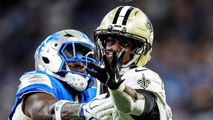 New Orleans Saints running back Travis Etienne Jr. (3) tries to catch the ball against Detroit Lions linebacker Devin White (45) during the overtime at Ford Field in Detroit on Sunday, Sept. 13, 2026.