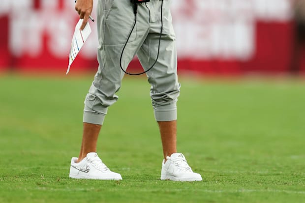 Miami Dolphins head coach Mike McDaniel stands on the field.