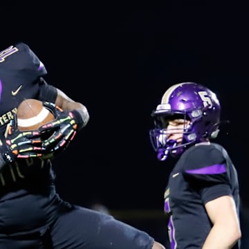 Western Beaver's Jeremiah Pratt intercepts a pass during the Golden Beavers' 41-14 win over Apollo-Ridge Friday in Industry, Pa.