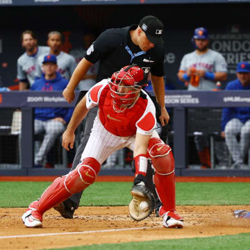 June 9, 2024; London, United Kingdom; New York Mets player Brandon Nimmo scores a run past Philadelphia Phillies catcher J.T. Realmuto during a London Series baseball game at Queen Elizabeth Olympic Park.