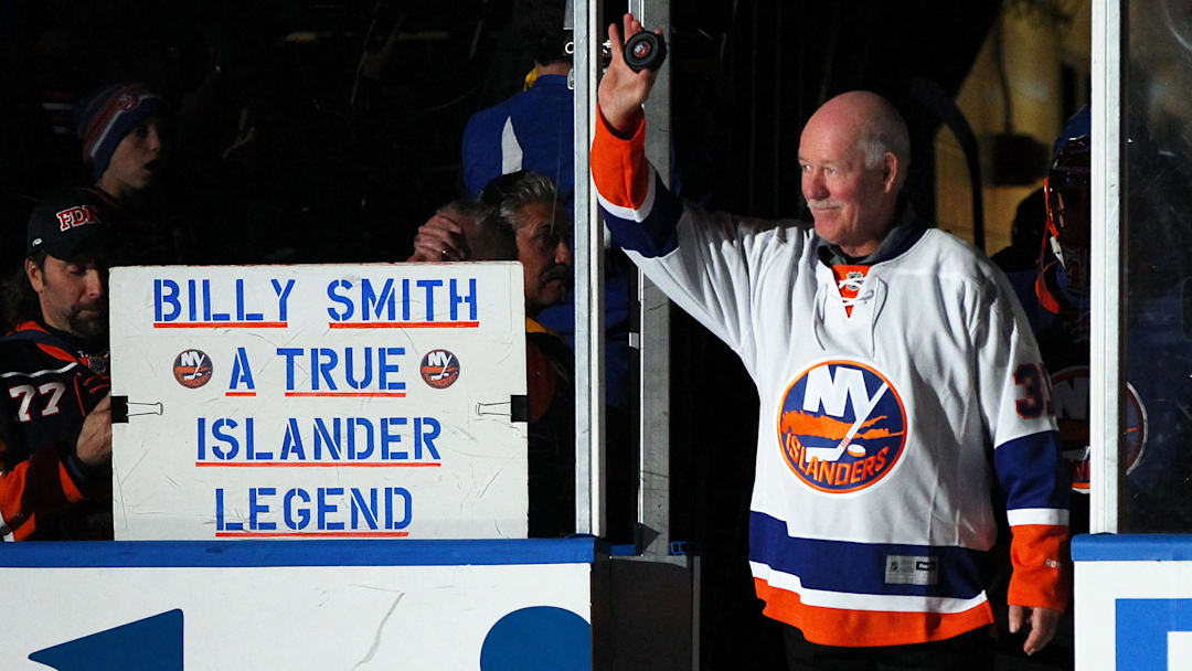 Nov 22, 2014; Uniondale, NY, USA; Former New York Islanders goaltender Billy Smith (R) leads the players onto the ice prior to the Islanders ' game against the Pittsburgh Penguins at Nassau Veterans Memorial Coliseum. Mandatory Credit: Andy Marlin-Imagn Images