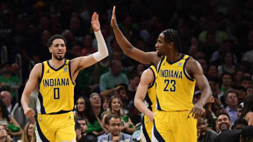 May 21, 2024; Boston, Massachusetts, USA; Indiana Pacers guard Tyrese Haliburton (0) reacts with forward Aaron Nesmith (23) during the second half for game one of the eastern conference finals for the 2024 NBA playoffs at TD Garden. Mandatory Credit: Bob DeChiara-USA TODAY Sports