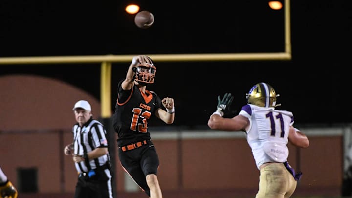 Brady Hart of Cocoa passes over Hunter Zirkle of Booker in the FHSAA football Class 2S state semifinal Friday, December 1, 2023.