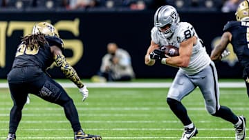 Dec 29, 2024; New Orleans, Louisiana, USA;  Las Vegas Raiders tight end Michael Mayer (87) rushes against New Orleans Saints linebacker Demario Davis (56) during the second half at Caesars Superdome. Mandatory Credit: Stephen Lew-Imagn Images