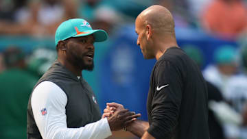 Dec 19, 2021; Miami Gardens, Florida, USA; Miami Dolphins head coach Brian Flores (L) meets with New York Jets head coach Robert Saleh (R) prior to the game at Hard Rock Stadium.