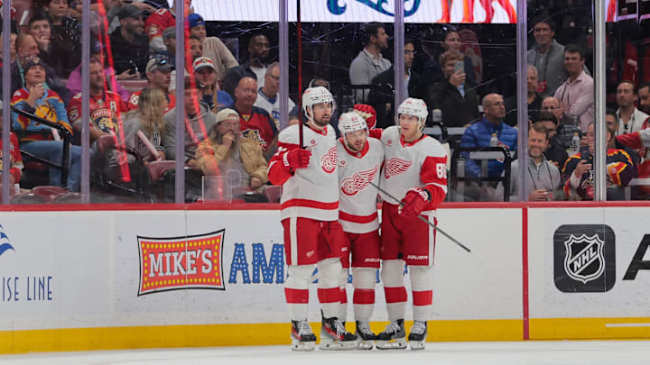 Apr 10, 2025; Sunrise, Florida, USA; Detroit Red Wings right wing Alex DeBrincat (93) celebrates with center Dylan Larkin (71) and right wing Patrick Kane (88) after scoring against the Florida Panthers during the first period at Amerant Bank Arena. Mandatory Credit: Sam Navarro-Imagn Images