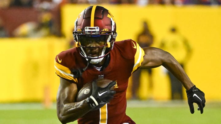 Aug 21, 2023; Landover, Maryland, USA; Washington Commanders wide receiver Jahan Dotson (1) runs after a catch against the Baltimore Ravens during the first half at FedExField. Mandatory Credit: Brad Mills-USA TODAY Sports