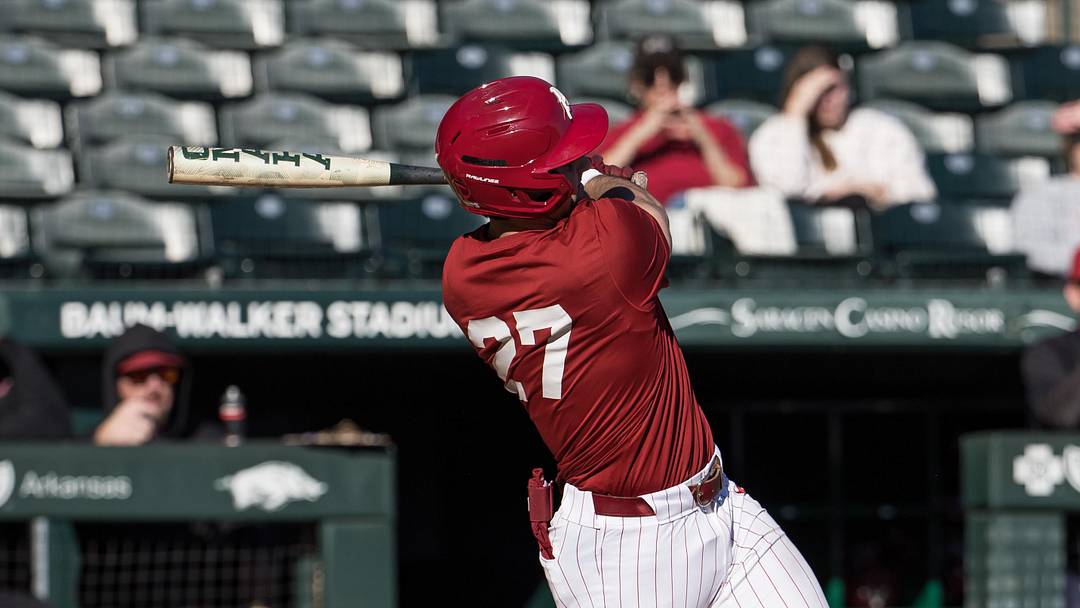Feb 6, 2026; Fayetteville, AR, USA;  Arkansas Razorbacks catcher Ryder Helfrick (27) hits a double during the third inning of the Arkansas Razorbacks scrimmage at Baum-Walker Stadium. Mandatory Credit: Brett Rojo-Imagn Images