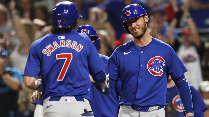 Aug 26, 2024; Pittsburgh, Pennsylvania, USA;  Chicago Cubs right fielder Cody Bellinger (24) greets shortstop Dansby Swanson (7) crossing home plate on a grand slam home run against the Pittsburgh Pirates during the sixth inning at PNC Park.