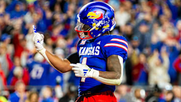 Nov 23, 2024; Kansas City, Missouri, USA;  Kansas running back Devin Neal (4) gestures after scoring a touchdown during the 4th quarter between the Kansas Jayhawks and the Colorado Buffaloes at GEHA Field at Arrowhead Stadium. 