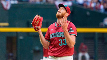 Mar 30, 2025; Phoenix, Arizona, USA;  Arizona Diamondbacks pitcher A.J. Puk (33) reacts after getting the final out of the game to beat the Chicago Cubs at Chase Field. Mandatory Credit: Allan Henry-Imagn Images