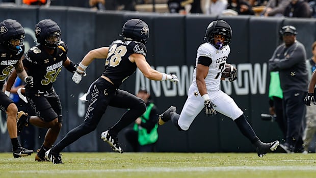Colorado Buffaloes running back Dallan Hayden (7) and safety Ben Finneseth (28) during the spring game at Folsom Field.