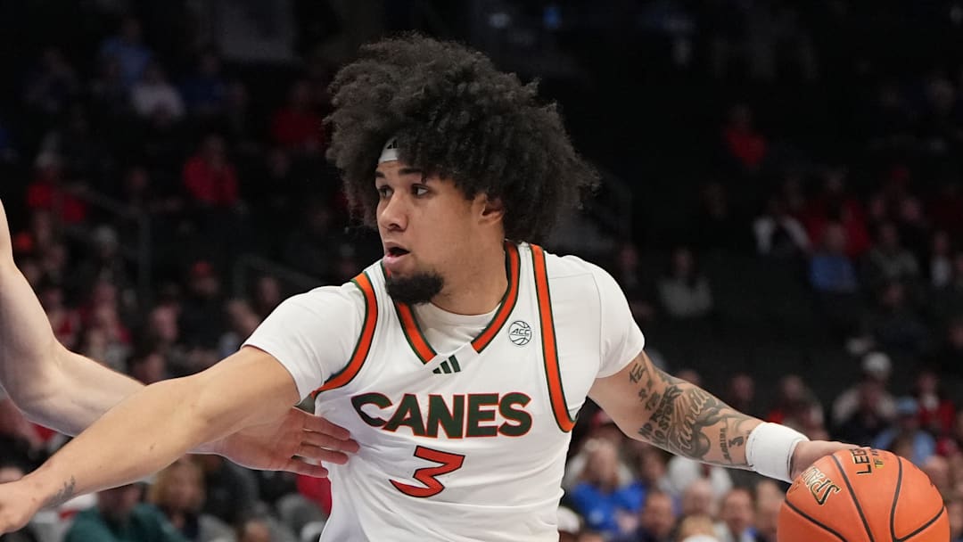 Mar 12, 2026; Charlotte, NC, USA; Miami (FL) Hurricanes guard Tre Donaldson (3) with the ball as Louisville Cardinals guard Isaac McKneely (10) defends in the second half at Spectrum Center. Mandatory Credit: Bob Donnan-Imagn Images