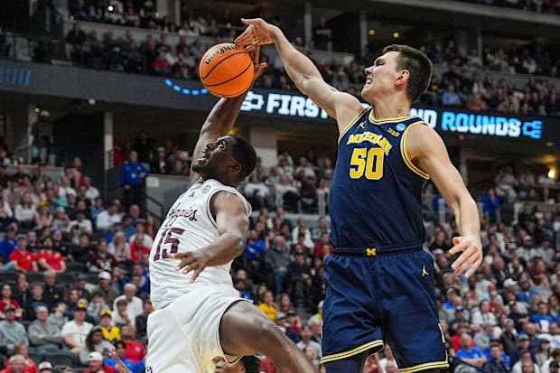 Michigan Wolverines center Vladislav Goldin (50) blocks the shot to Texas A&M Aggies forward Henry Coleman III (15).