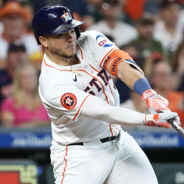 Jun 23, 2024; Houston, Texas, USA; Houston Astros designated hitter Yainer Diaz (21) hits a RBI sacrifice against the Baltimore Orioles in the fourth inning at Minute Maid Park.
