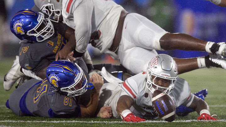UNLV linebacker Marsel McDuffie reaches for the ball.
