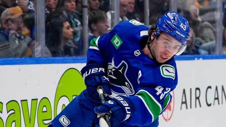 Quinn Hughes fires the puck toward the net against the St. Louis Blues.