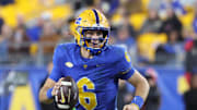 Oct 25, 2025; Pittsburgh, Pennsylvania, USA;  Pittsburgh Panthers quarterback Mason Heintschel (6) scrambles with the ball against the North Carolina State Wolfpack during the fourth quarter at Acrisure Stadium. Mandatory Credit: Charles LeClaire-Imagn Images