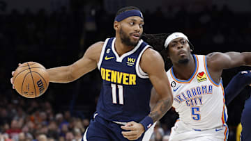 Nov 23, 2022; Oklahoma City, Oklahoma, USA; Denver Nuggets forward Bruce Brown (11) dribbles the ball around Oklahoma City Thunder forward Luguentz Dort (5) during the first quarter at Paycom Center. Mandatory Credit: Alonzo Adams-Imagn Images