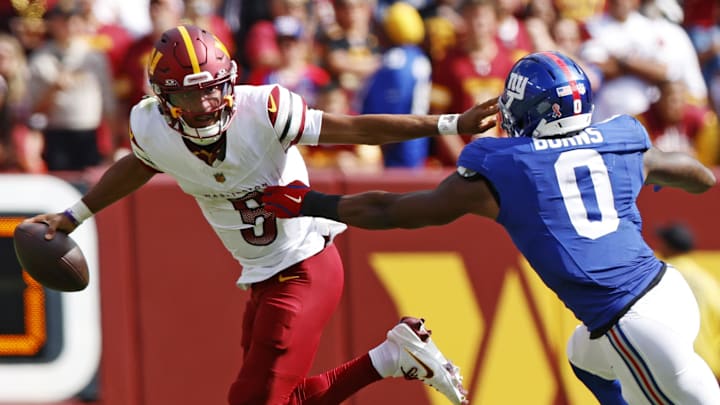 Washington Commanders quarterback Jayden Daniels (5) runs the ball during the fourth quarter against Giants edge Brian Burns. Washington Commanders quarterback Jayden Daniels (5) runs the ball during the fourth quarter against Giants edge Brian Burns.