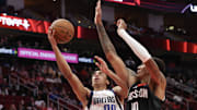 Mar 14, 2025; Houston, Texas, USA;  Dallas Mavericks guard Max Christie (00) shoots against Houston Rockets forward Jabari Smith Jr. (10) in the second half at Toyota Center. Mandatory Credit: Thomas Shea-Imagn Images