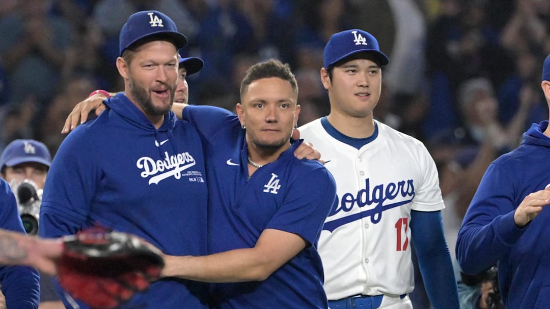 Sep 26, 2024; Los Angeles, California, USA;  Los Angeles Dodgers starting pitcher Clayton Kershaw (22), shortstop Miguel Rojas (11) and designated hitter Shohei Ohtani (17) after clinching the National League West by defeating the San Diego Padres 7-2 at Dodger Stadium. Mandatory Credit: Jayne Kamin-Oncea-Imagn Images