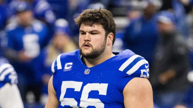 Indianapolis Colts offensive guard Quenton Nelson preps for a game while wearing no helmet and a blue football jersey. 