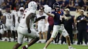 Sep 26, 2025; Charlottesville, Virginia, USA; Virginia Cavaliers quarterback Chandler Morris (4) passes the ball as Florida State Seminoles defensive lineman Darrell Jackson Jr. (6) chases at Scott Stadium. Mandatory Credit: Geoff Burke-Imagn Images