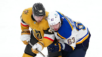 Oct 11, 2024; Las Vegas, Nevada, USA; Vegas Golden Knights center Ivan Barbashev (49) defends against St. Louis Blues left wing Jake Neighbours (63) during the third period at T-Mobile Arena. Mandatory Credit: Stephen R. Sylvanie-Imagn Images