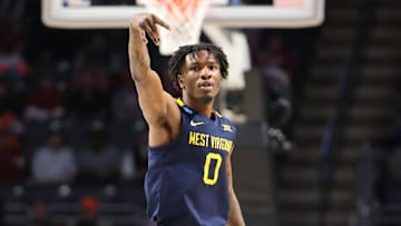 Mar 16, 2023; Birmingham, AL, USA; West Virginia Mountaineers guard Kedrian Johnson (0) celebrates a three-point basket against the Maryland Terrapins during the second half in the first round of the 2023 NCAA Tournament at Legacy Arena. Mandatory Credit: Vasha Hunt-Imagn Images