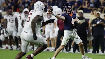 Sep 26, 2025; Charlottesville, Virginia, USA; Virginia Cavaliers quarterback Chandler Morris (4) passes the ball as Florida State Seminoles defensive lineman Darrell Jackson Jr. (6) chases at Scott Stadium. Mandatory Credit: Geoff Burke-Imagn Images